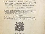 an old book with writing on it sitting on a table