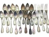 a lot of silver spoons and forks on a table