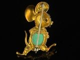 an image of a gold and turquoise enamel mouse with a sword