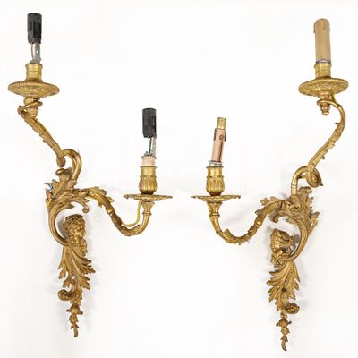 pair of antique brass wall sconces with two candles on each of them