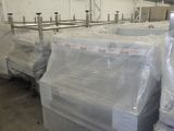 many bags of plastic sitting on the floor in a warehouse