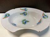 a white plate with blue and green flowers on it