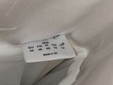the label on a white shirt is attached to the back of a white shirt