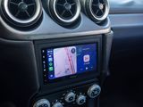 the dashboard of a car with a gps device in the center of it