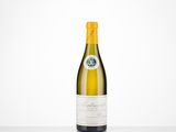 a bottle of white wine sitting on top of a table