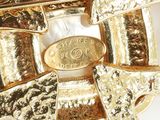 an image of a gold plated brooch with a horse on it ' s back