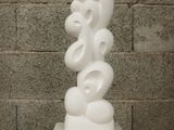 a white sculpture sitting on top of a wooden table
