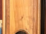 a tall wooden cabinet with a mirror on top of it