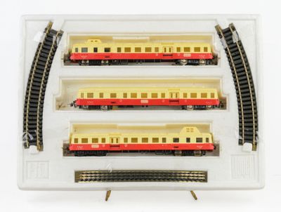three trains that are sitting in a display case
