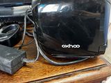 a black toaster sitting on top of a wooden table