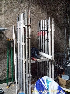 a bunch of pipes that are stacked up in a room