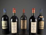 six bottles of wine are lined up in a row on a table