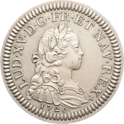 gros plan d'une pièce de monnaie sur laquelle figure une tête de femme