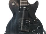 an image of a black electric guitar on a stand