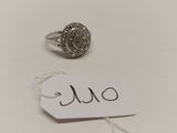 une photo d'une bague et d'une étiquette de prix posées sur une table