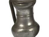a silver pitcher with a handle on a white background