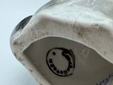 a white porcelain figurine with a black and white design on it