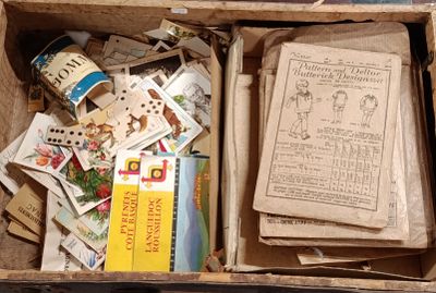 a box full of books and papers on the floor