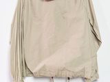 an image of a beige jacket hanging on a hanger