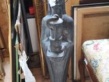 a statue of a woman holding a vase in a room