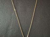 a gold necklace with a star pendant on it