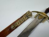 a knife that is sitting next to a knife on a table