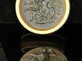 a gold coin with a picture of a woman on it