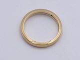 an image of a gold ring on a white surface