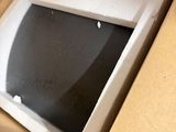 a person opening a box with a computer inside of it