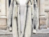 un manteau posé sur un mannequin devant un immeuble