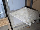 boxes and pallets are stacked on top of each other in a room
