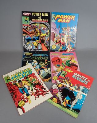 a group of comic books sitting on top of a table