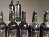 several bottles of wine are lined up in a row on a table