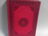 an old red book with a black border on the cover