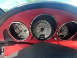 trois jauges sur le tableau de bord d'une voiture rouge