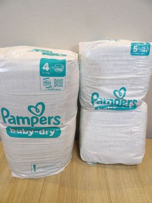 two packs of diapers sitting on top of each other on a table