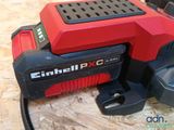 an image of a red and black power tool on a wooden surface
