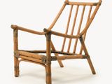 a chair made out of bamboo sticks on a white background