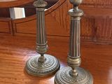two candles that are sitting on a wooden table
