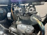 a close up of a motorcycle engine on the street