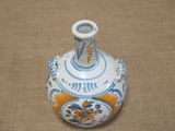 a blue and white vase sitting on a brown surface