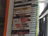 a lot of dvds stacked on a shelf in a room