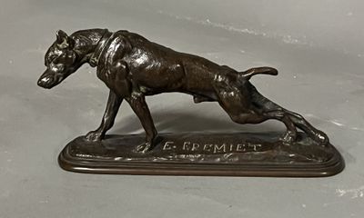 bronze statue of a dog on a base with a name plate