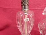 pair of antique cut glass perfume bottles on a red background