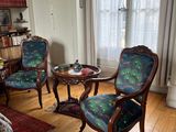 two chairs and a table in a living room