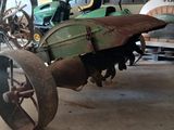 a small tractor with a large tire in a garage