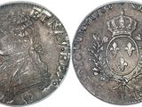 a close up of a coin with a crown on it