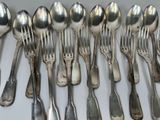 a lot of silver spoons and forks on the table