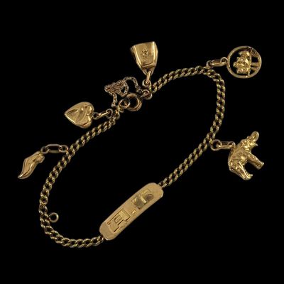 un bracelet en or avec des breloques et des pendentifs sur une chaîne