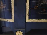 a blue cabinet with a gold decoration on it